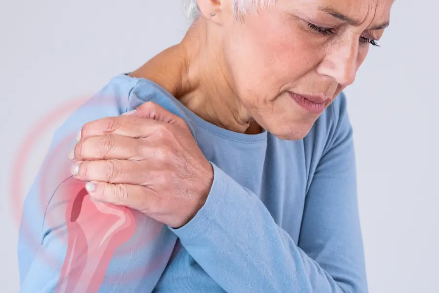 Person grabbing shoulder in pain | Reverse Shoulder Replacement Surgery at Capital Surgical Associates